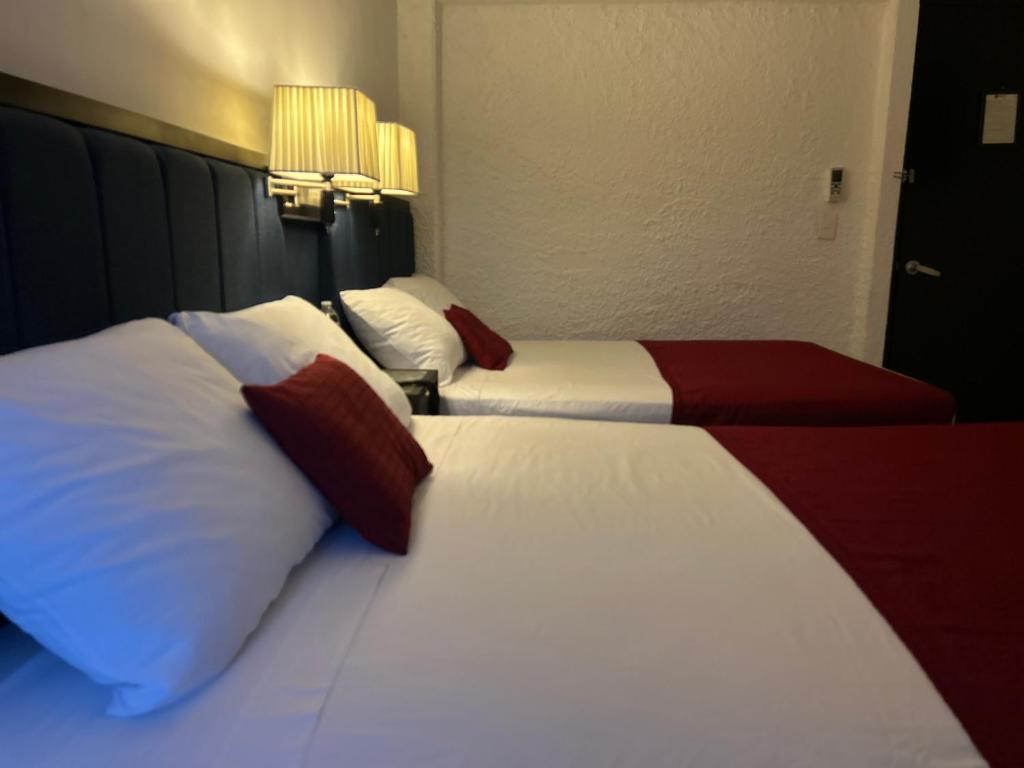 Postel nebo postele na pokoji v ubytování Choco's Hotel