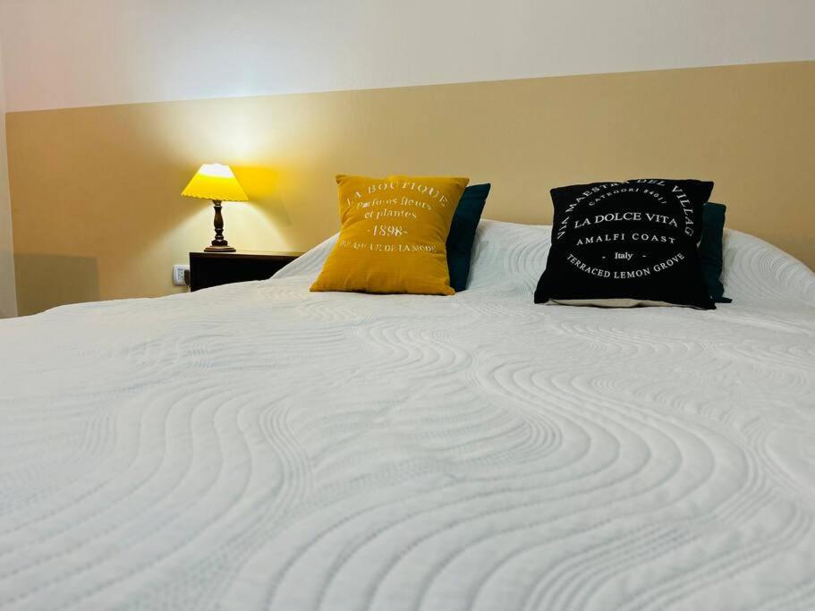 a large white bed with two pillows on it at GRAN habitación céntrica Iguazú 1-A in Puerto Iguazú