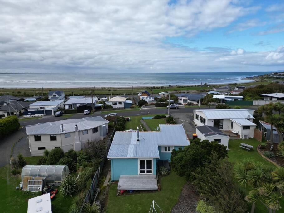 an aerial view of a small town with houses and the ocean at Beach Bliss Retreat in Riverton