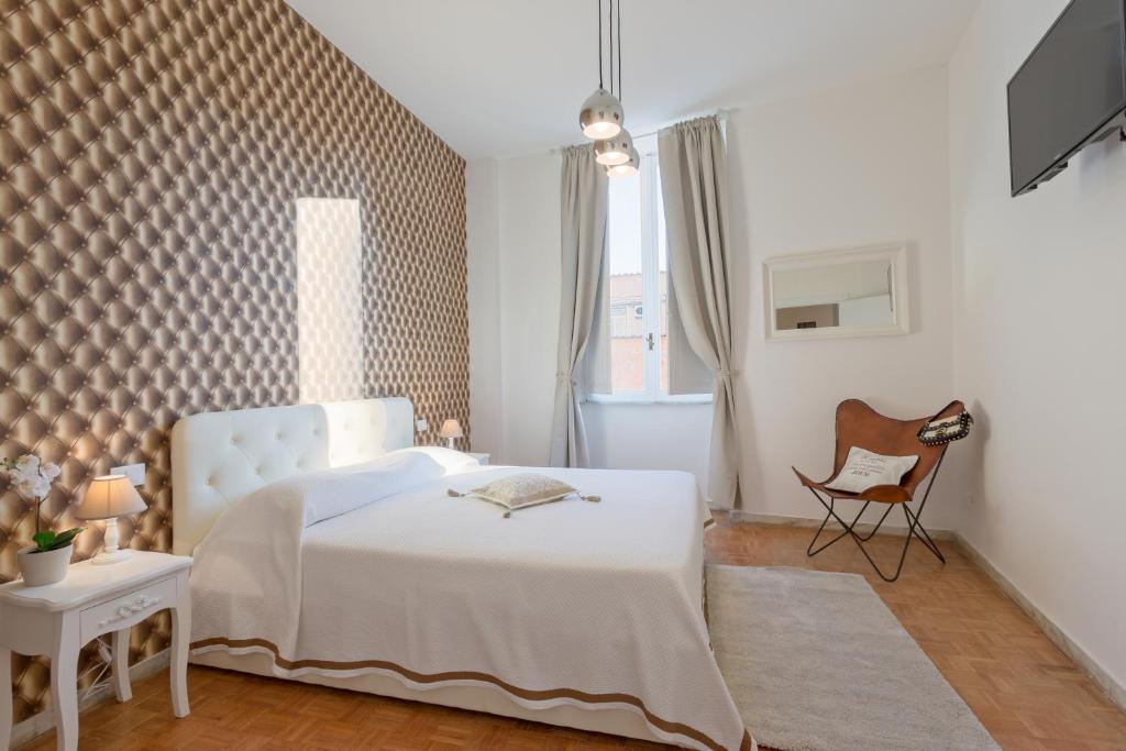 - une chambre avec un lit blanc et une chaise dans l'établissement TownHouse by the Spanish Steps, à Rome