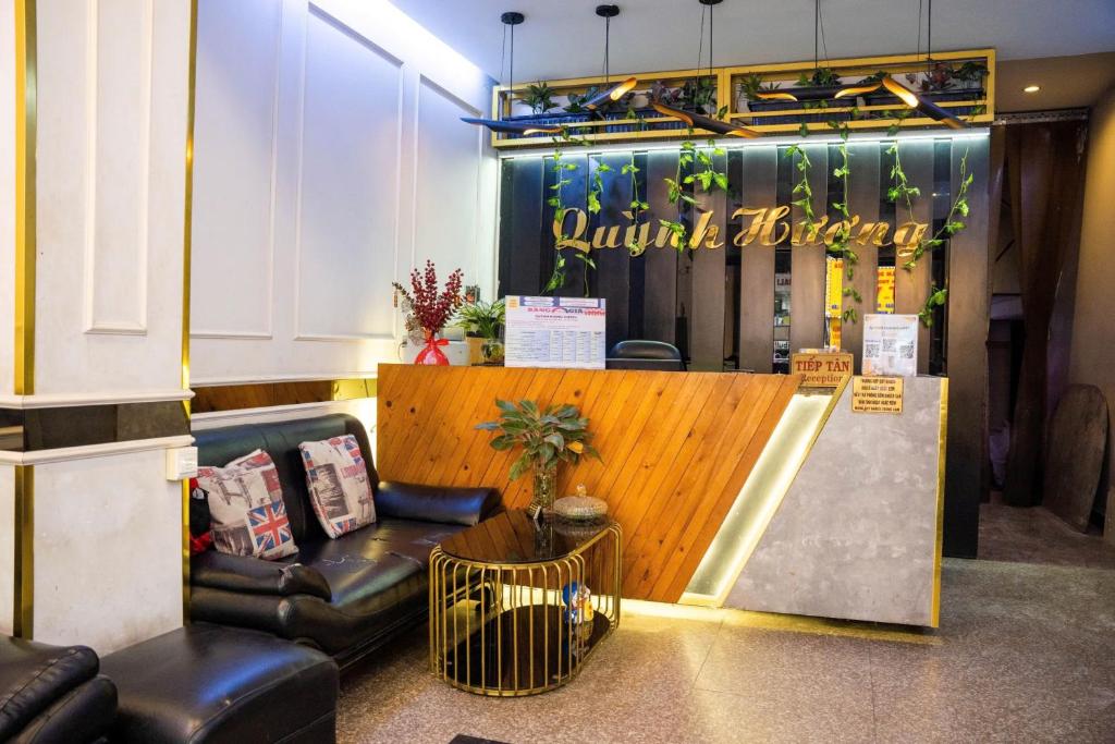 a waiting room with a couch and a counter at Quỳnh Hương Hotel Phú Nhuận in Ho Chi Minh City