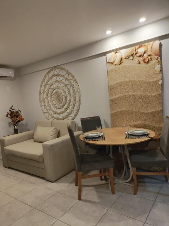 a living room with a couch and a table at Flat Beira Mar Meireles in Fortaleza