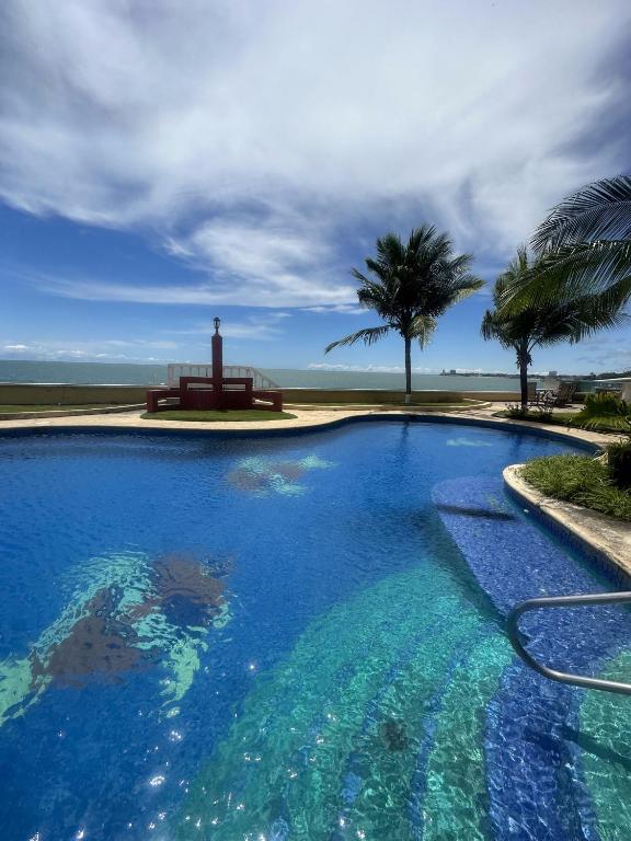 a swimming pool with a view of the ocean at En el Mar in Nueva Gorgona