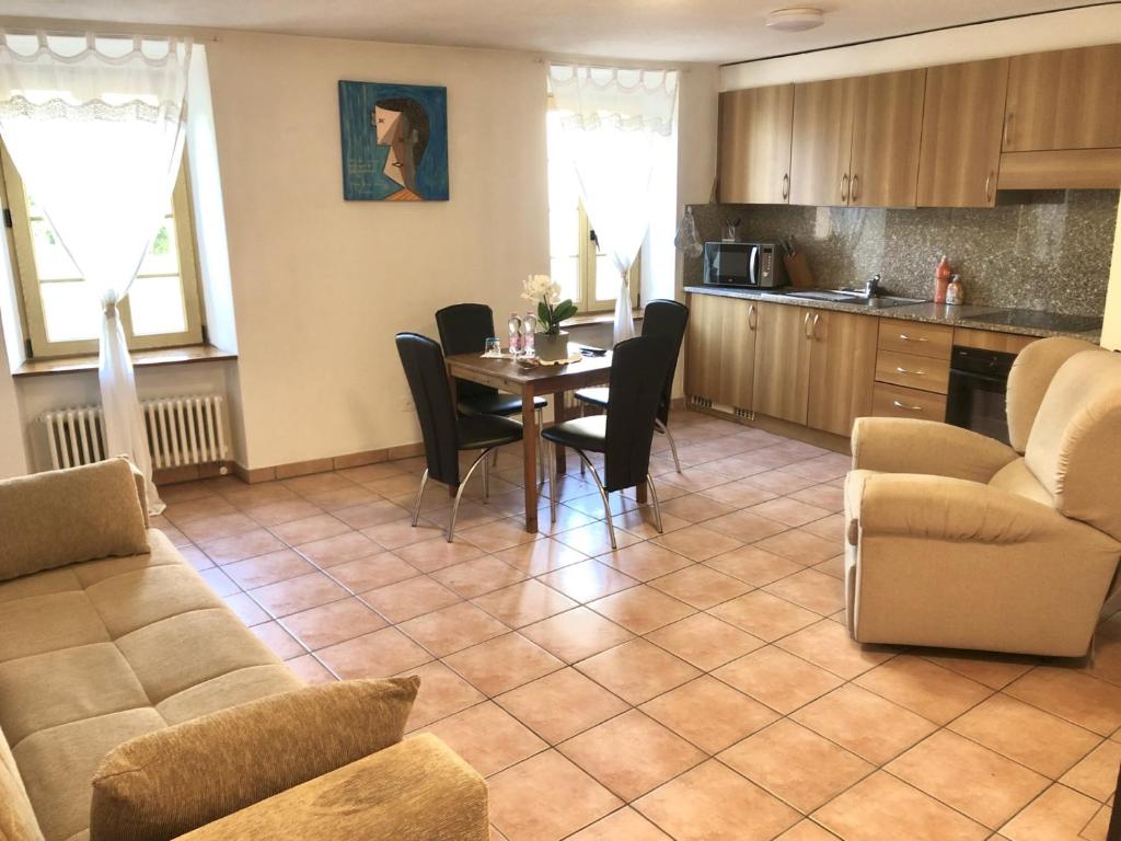 a kitchen and dining room with a table and chairs at Vacanza a Miglieglia in Miglieglia