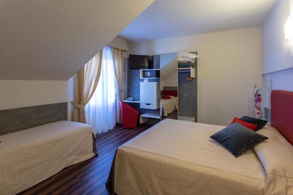 Postel nebo postele na pokoji v ubytování Hotel Le Palme