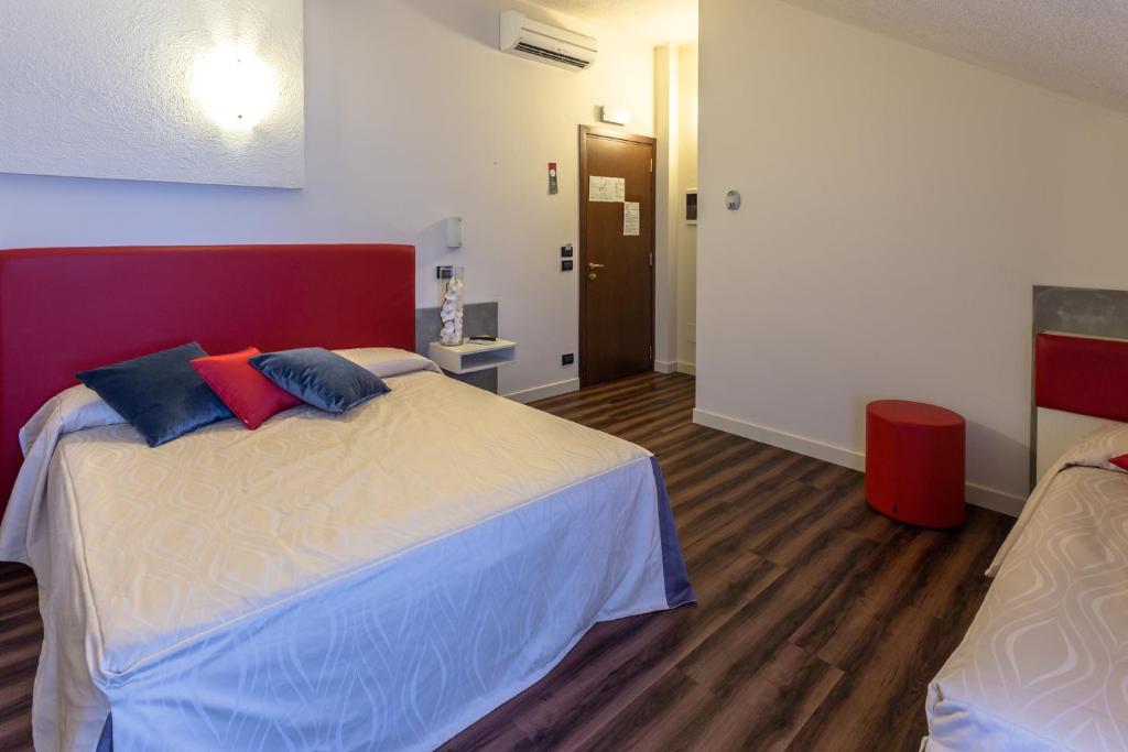 Postel nebo postele na pokoji v ubytování Hotel Le Palme