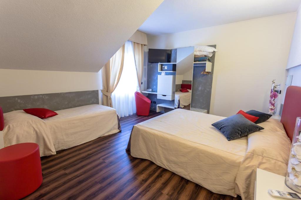 Postel nebo postele na pokoji v ubytování Hotel Le Palme