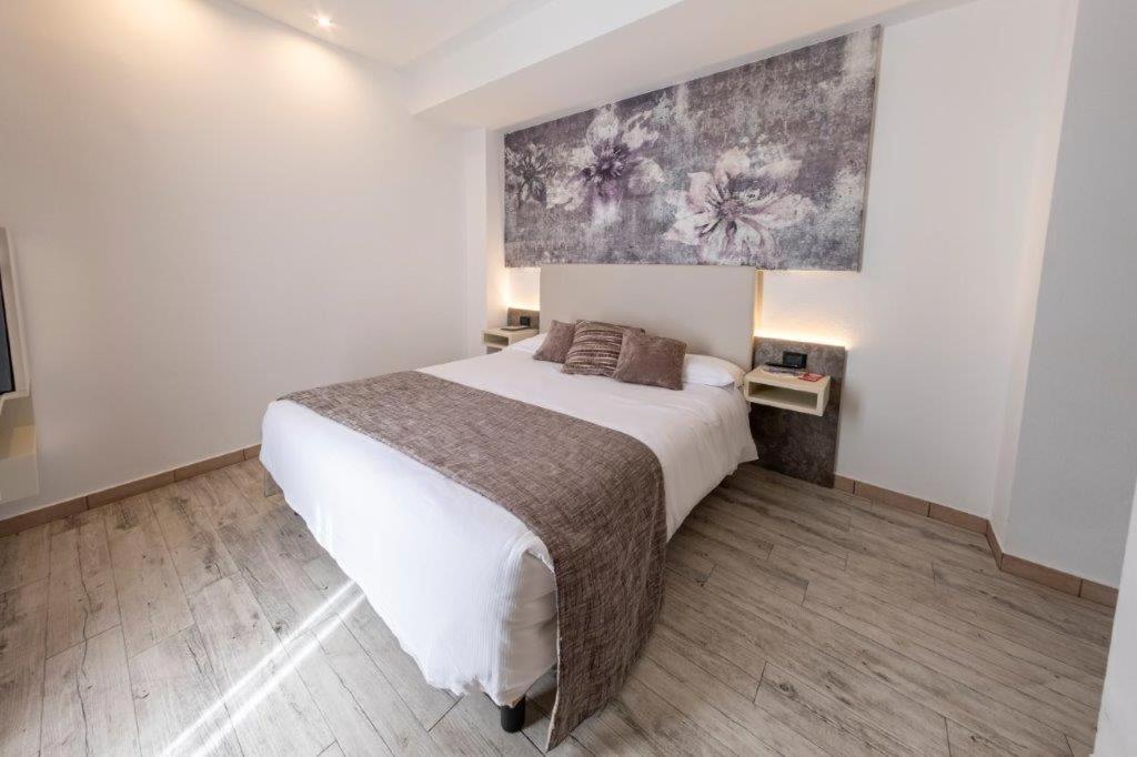 Postel nebo postele na pokoji v ubytování Hotel Le Palme