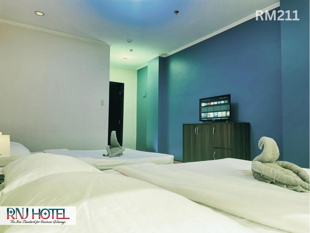 Postel nebo postele na pokoji v ubytování RNJ Hotel
