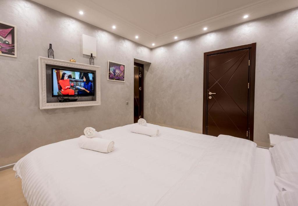 Postel nebo postele na pokoji v ubytování Grande Apartments