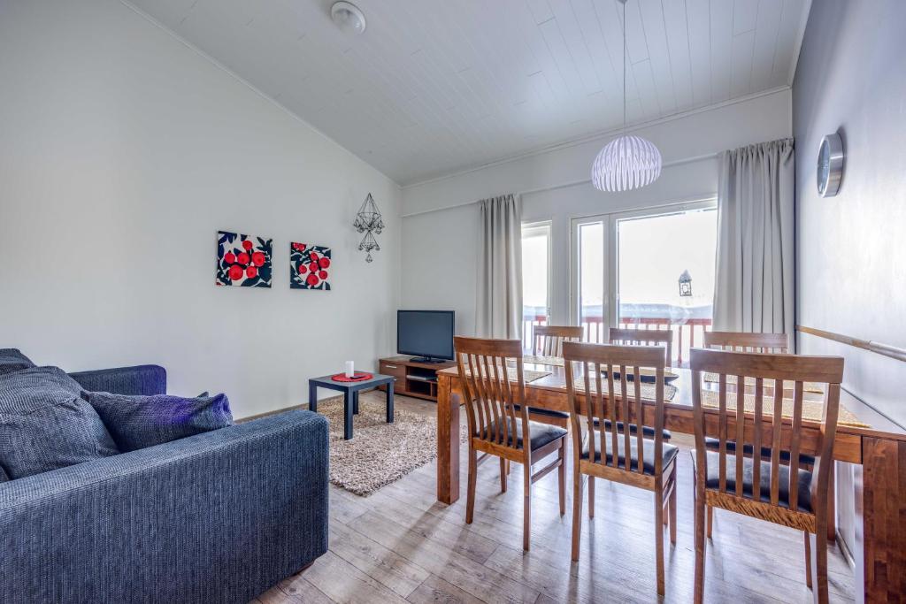 a living room with a couch and a table and chairs at Holiday Apartment Skivillas 26 B 9 in Ukkohalla