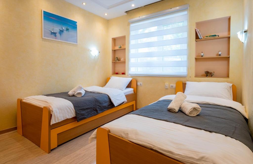 Postel nebo postele na pokoji v ubytování Grande Apartments