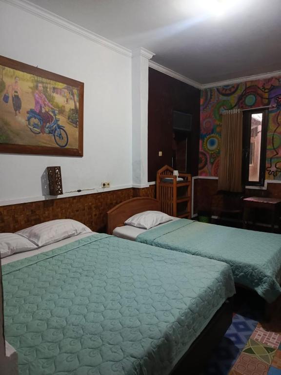 Postel nebo postele na pokoji v ubytování Mini Tiga Homestay