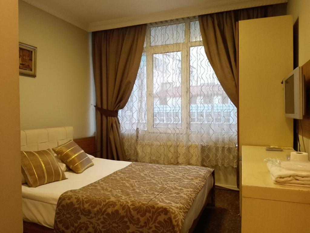 Postel nebo postele na pokoji v ubytování Tac Hotel