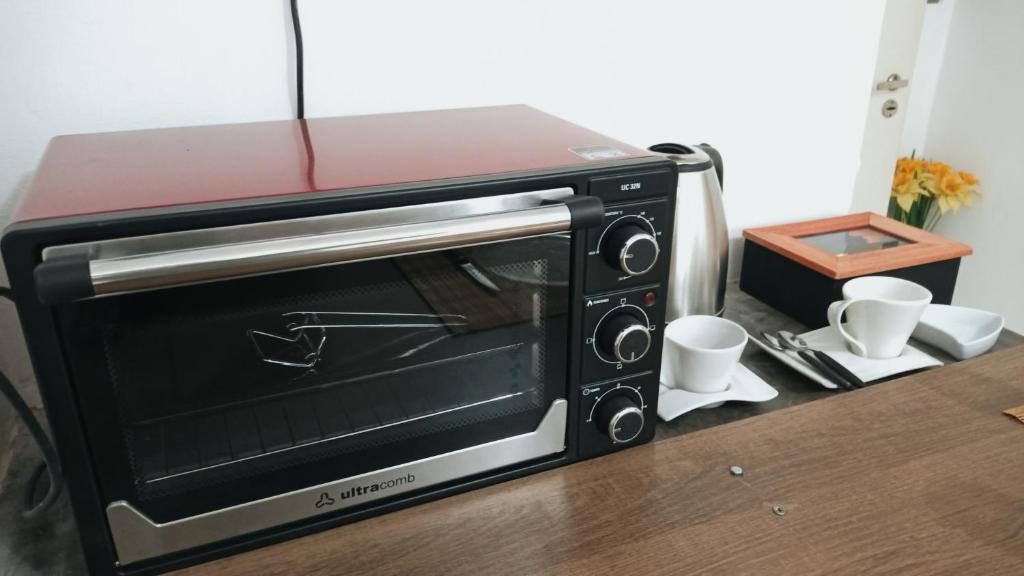 a microwave oven sitting on top of a counter at Departamento - M I N I D O in Resistencia