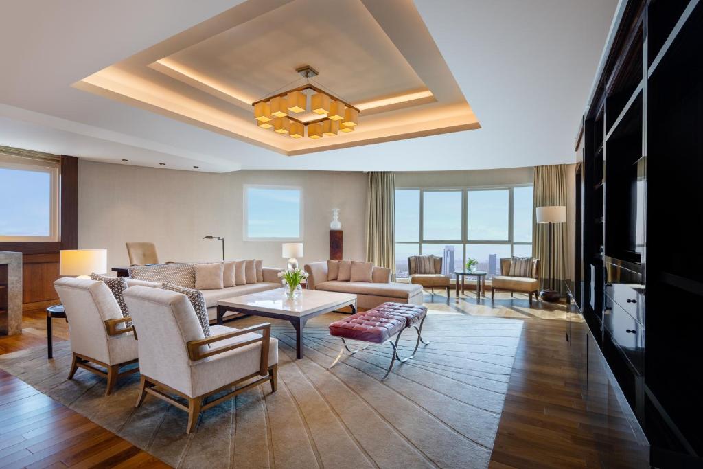 a living room with a couch and a table at Grand Millennium Al Wahda Hotel and Executive Apartments Abu Dhabi in Abu Dhabi