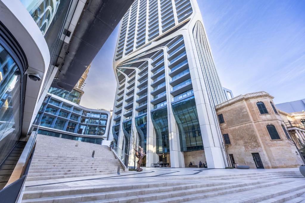 a tall building with stairs in front of it at Exquisite Residence in Mercury Towers in St. Julianʼs