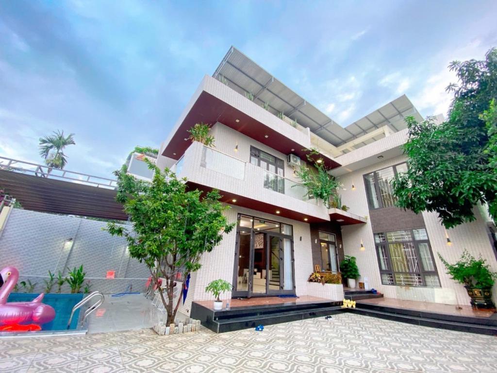 a house with a swimming pool in front of it at Phúc Villa in Da Nang