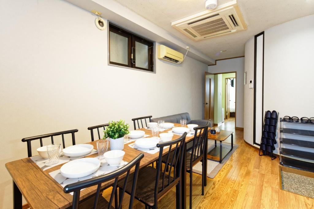 a dining room with a long table and chairs at TwinB Building 5 Haruoka 2F - Vacation STAY 17506 in Nagoya