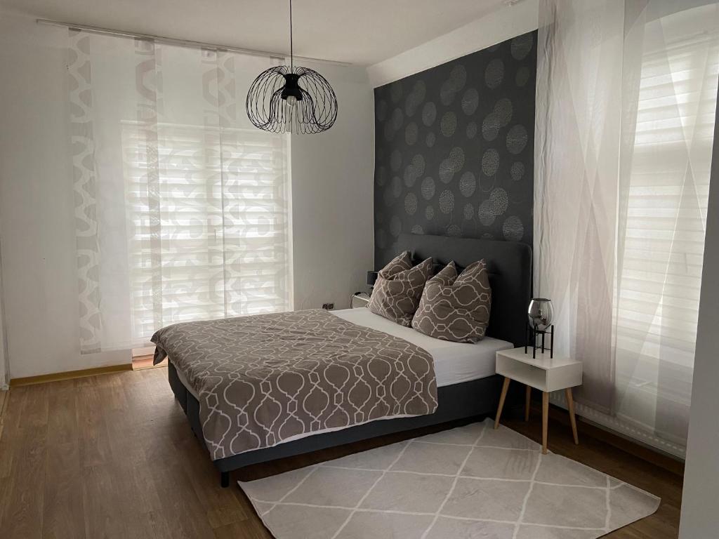 a bedroom with a large bed and a chandelier at Ferienwohnung in Bad Wildungen, Erdgeschoß in Bad Wildungen