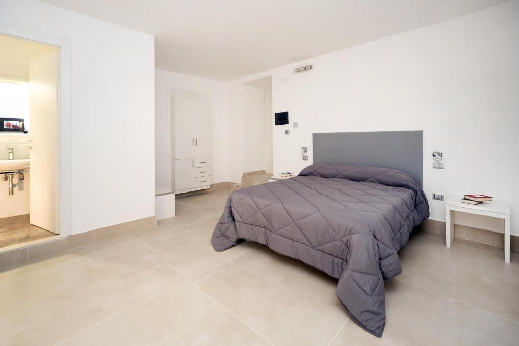 Postel nebo postele na pokoji v ubytování Il Tesoro Smart Suite & SPA