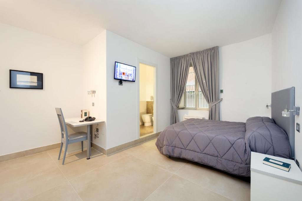 Postel nebo postele na pokoji v ubytování Il Tesoro Smart Suite & SPA