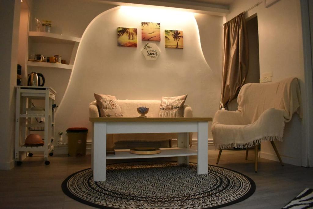 a living room with a table and a chair at Anna's Guesthouse in Cluj-Napoca
