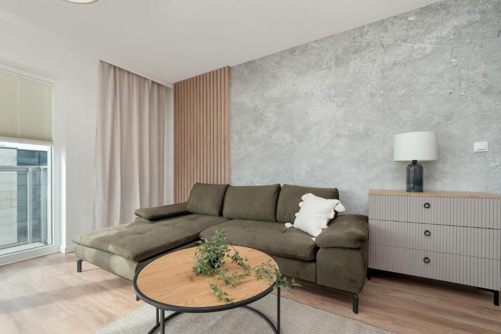 a living room with a couch and a table at Kilińskiego Prestigious Apartment with Parking by Renters Prestige in Łódź