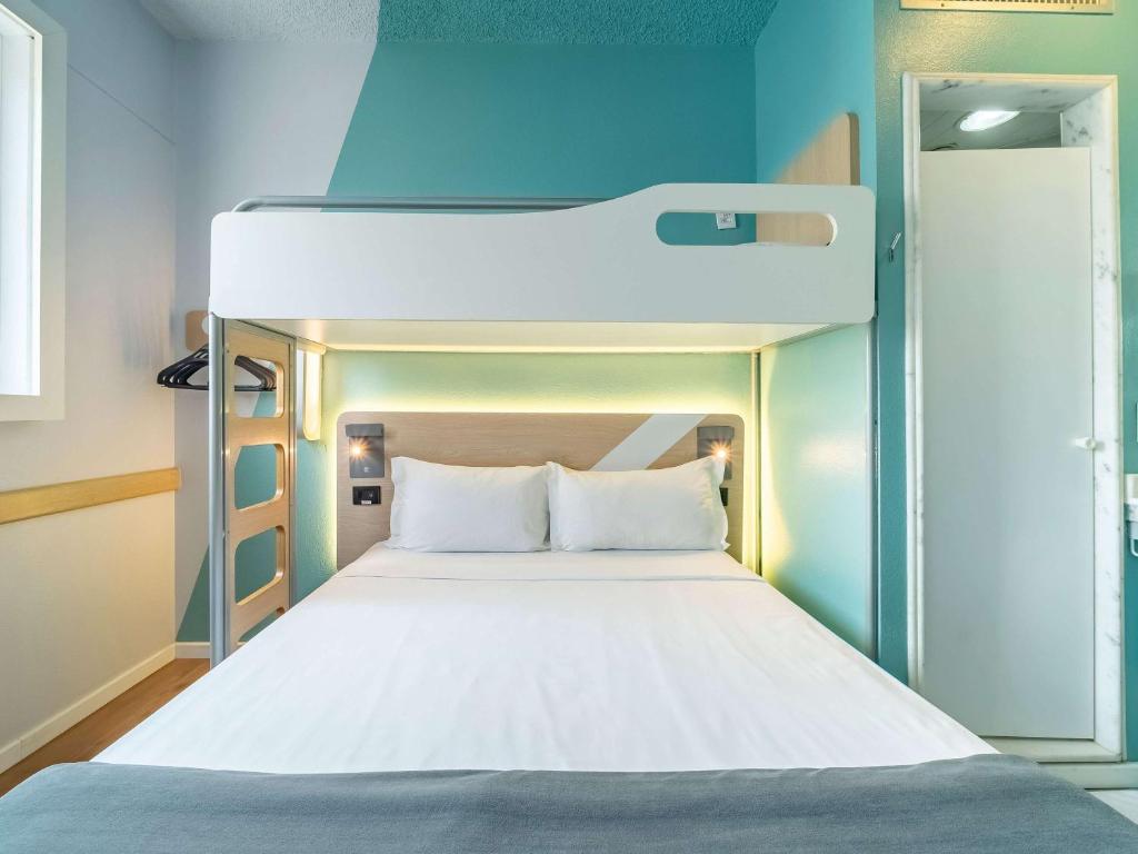 Cama ou camas em um quarto em ibis budget Sao Paulo Jardins