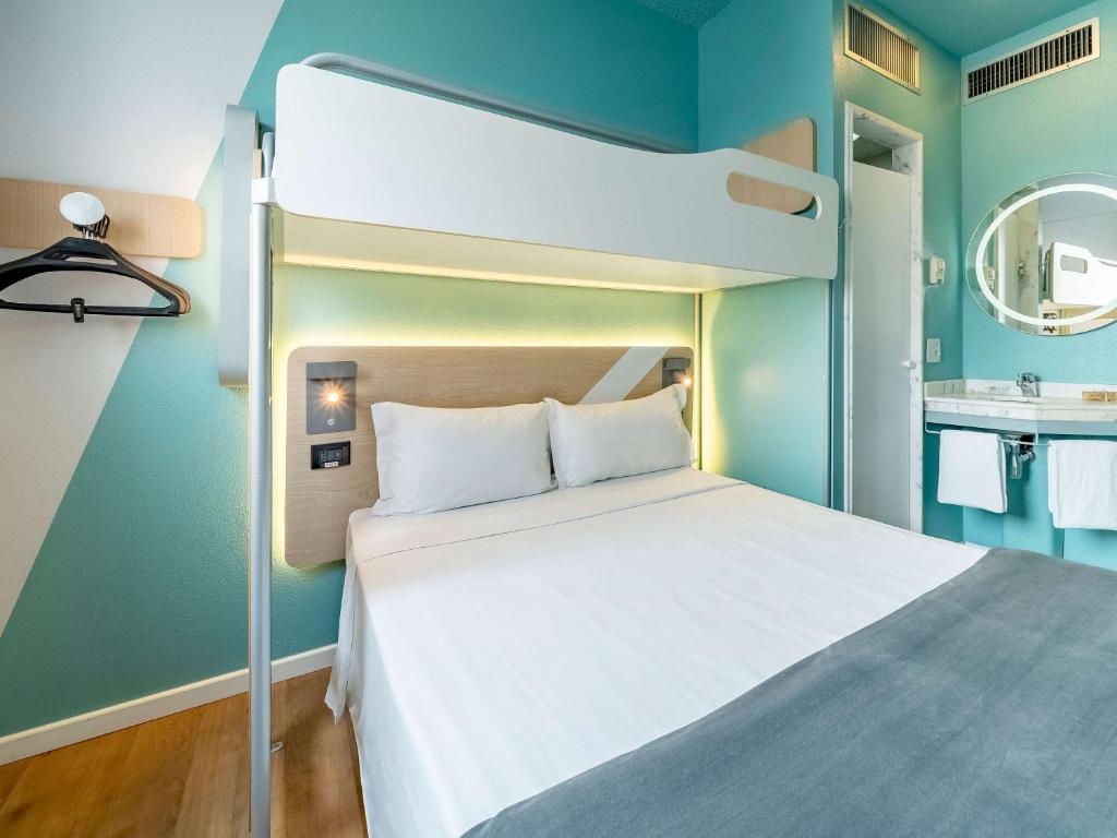 Cama ou camas em um quarto em ibis budget Sao Paulo Jardins