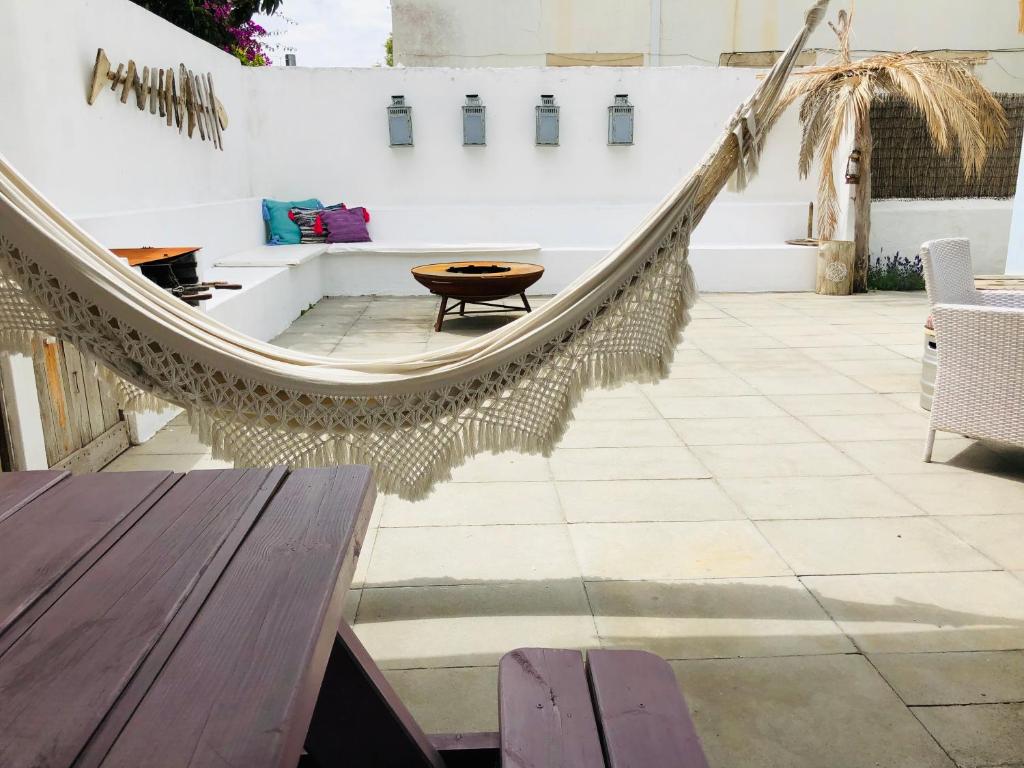 a hammock in the middle of a patio at Aloha Beach House H in Cascais