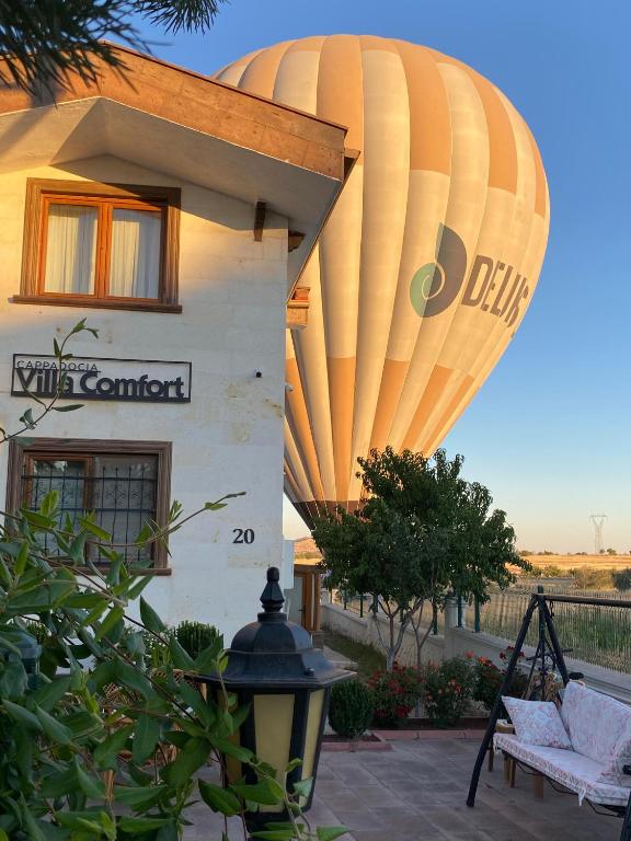 a large hot air balloon sitting outside of a building at Cappadocia Villa Comfort in Nevşehir