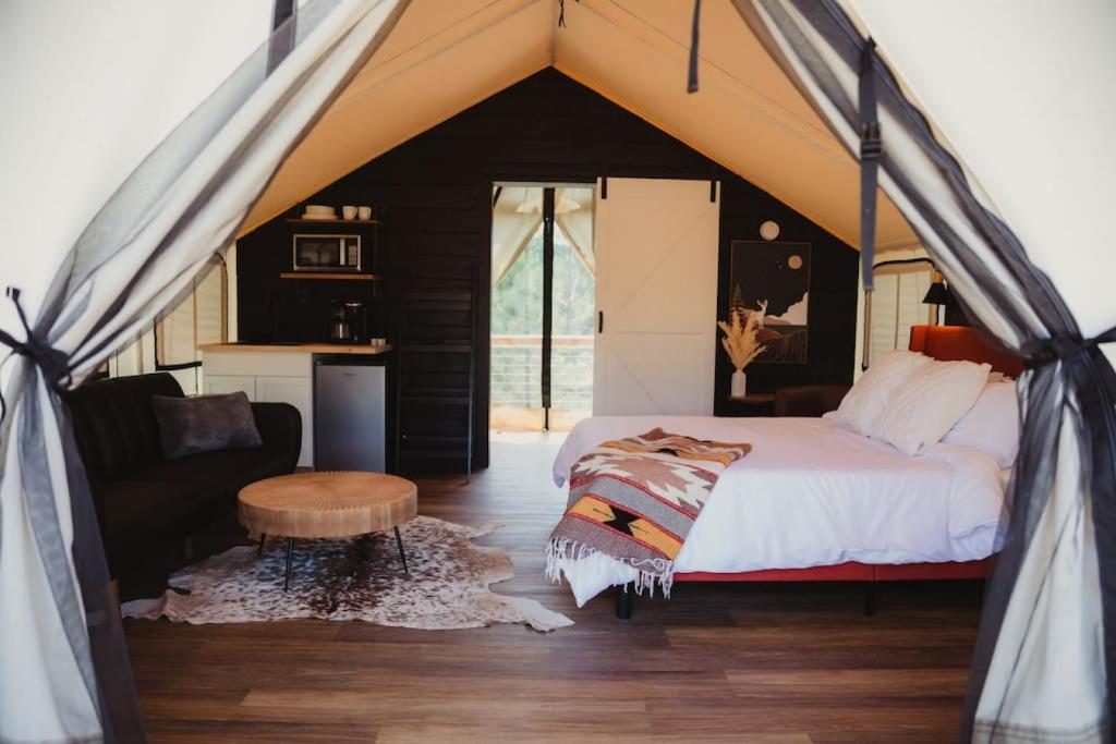 a bedroom with a bed in a tent at The Richbourg, Lux Safari Tent in Cadiz
