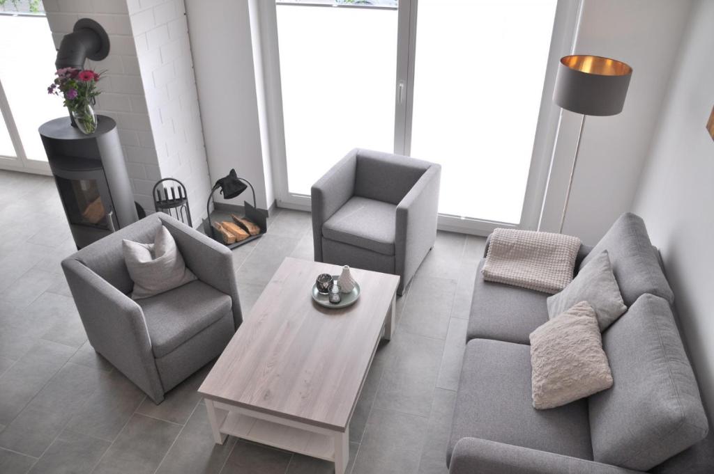 a living room with a couch and two chairs and a table at Vechtestübchen - Nordhorn in Nordhorn