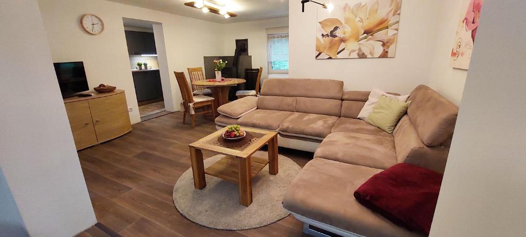 a living room with a couch and a table at Ferienhaus Wald-Idyll Meisdorf in Meisdorf