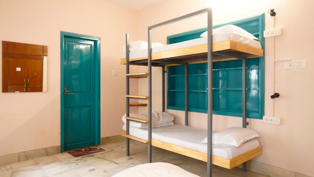 Postel nebo postele na pokoji v ubytování Roambay - Gokulam