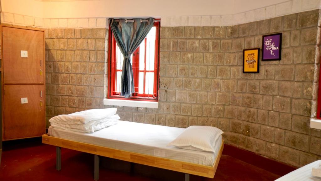 Postel nebo postele na pokoji v ubytování Roambay - Gokulam
