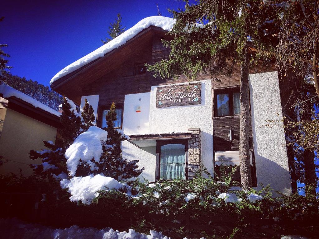 a sign on the side of a building in the snow at B&B Villa Fiorita in Roccaraso