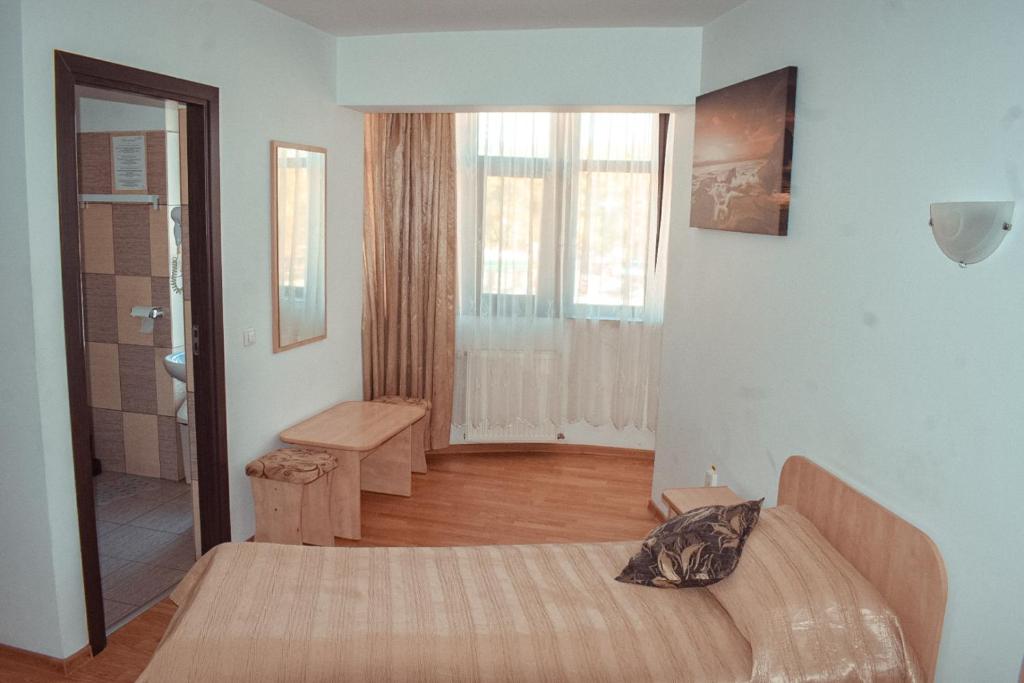 Postel nebo postele na pokoji v ubytování Pensiunea Belvedere