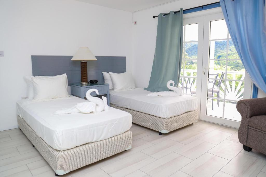 Postel nebo postele na pokoji v ubytování Sugarmon Villas