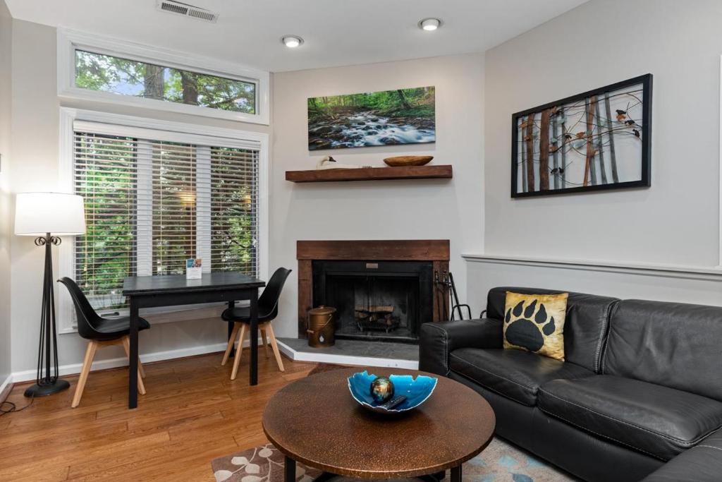 a living room with a black couch and a piano at Three Ridges 74 with Wintergreen Advantage in Wintergreen
