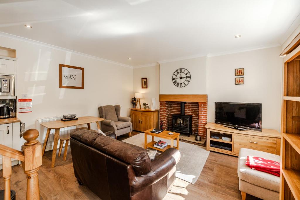 a living room with a couch and a fireplace at Star Cottage - Harbottle - Nr Rothbury - Northumberland in Morpeth
