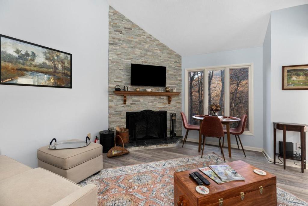 a living room with a couch and a fireplace at Laurelwood 43 with Wintergreen Advantage in Wintergreen