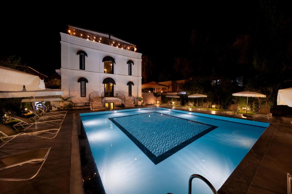 a swimming pool in front of a house at night at Onyour Dreams Belek in Belek