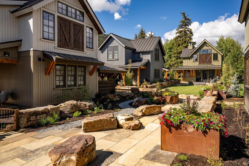 a yard with rocks and a house at Academy Place | Bluebell in Crested Butte