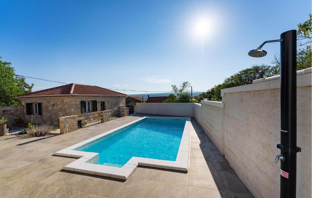 a swimming pool on the side of a house at 4 Bedroom Cozy Home In Krusevo in Kruševo