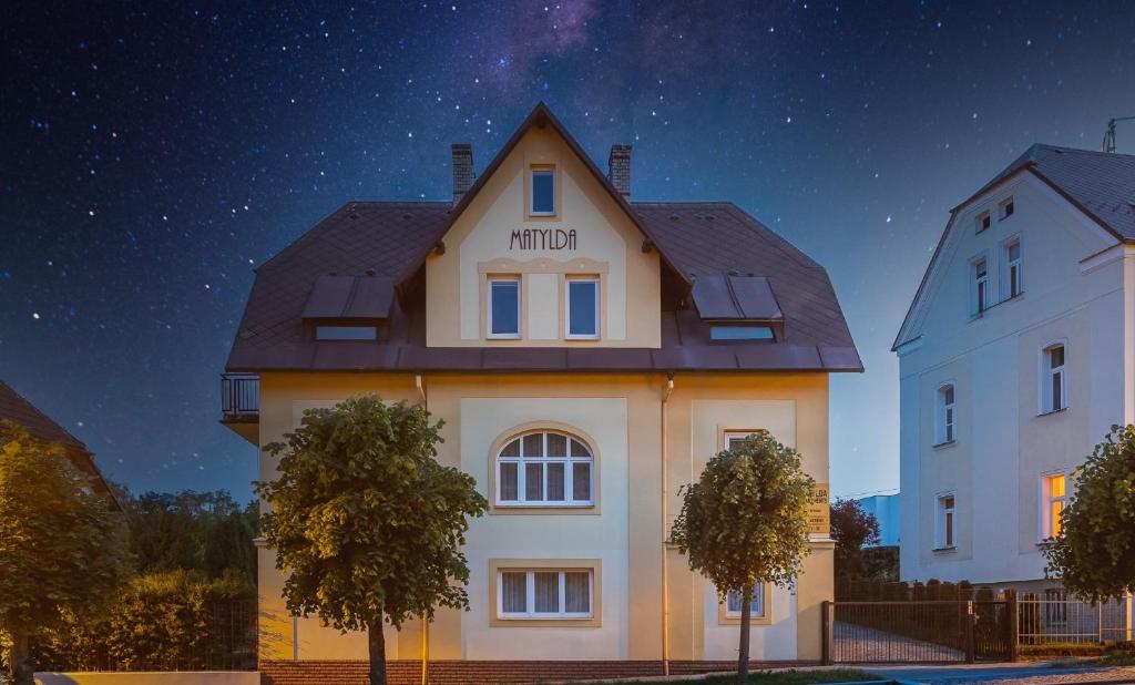 duży biały budynek w nocy z gwiezdnym niebem w obiekcie Villa Matylda w Mariańskich Łaźniach