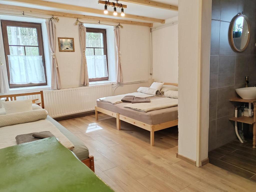 a living room with a bed and a couch at Parittyaház in Homokmégy