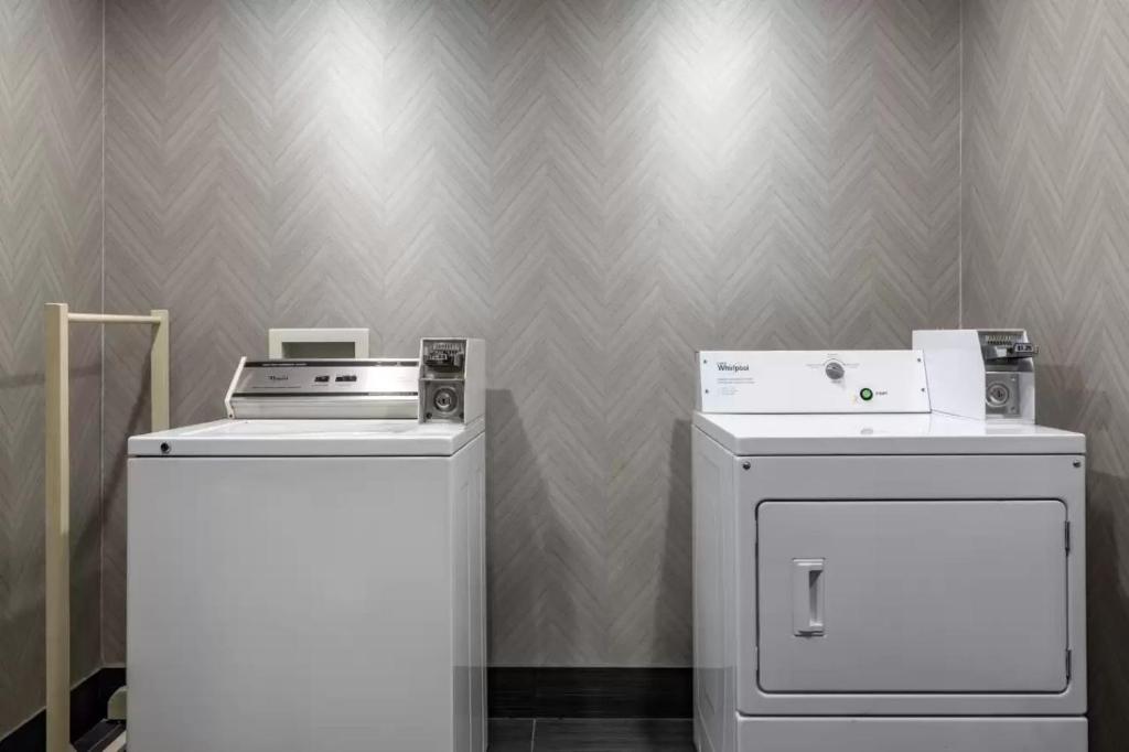 two machines and a washer and dryer in a room at Comfort Inn & Suites Pauls Valley - City Lake in Pauls Valley