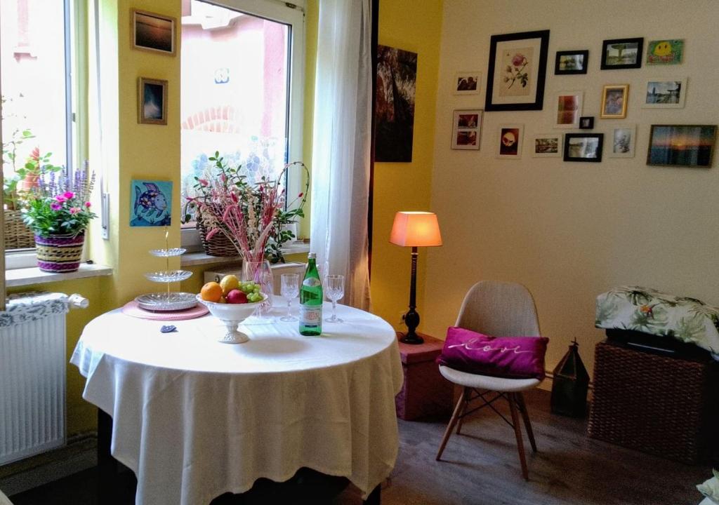 a table with a bowl of fruit on it in a room at Frankfurt am Main 15 Min from Messe, City and ECB in Frankfurt/Main